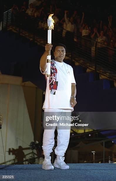 Muhammad Ali holds the torch before lighting the Olympic Flame during the Opening Ceremony of the 1996 Centennial Olympic Games in Atlanta, Georgia.