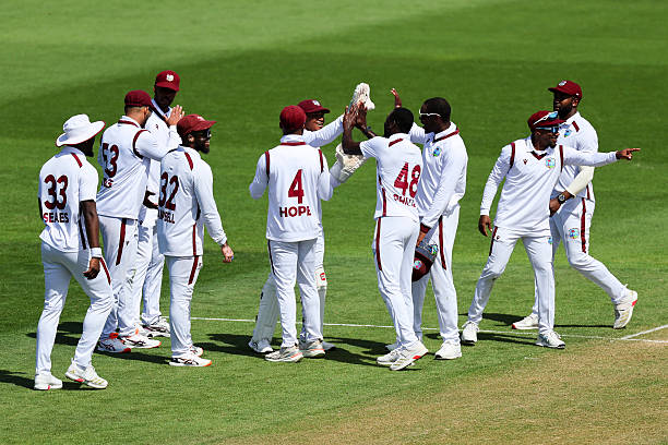 West Indies players celebrate the wicket of Daryl Mitchell of New Zealand during day two of the second Test match in the series between New Zealand...