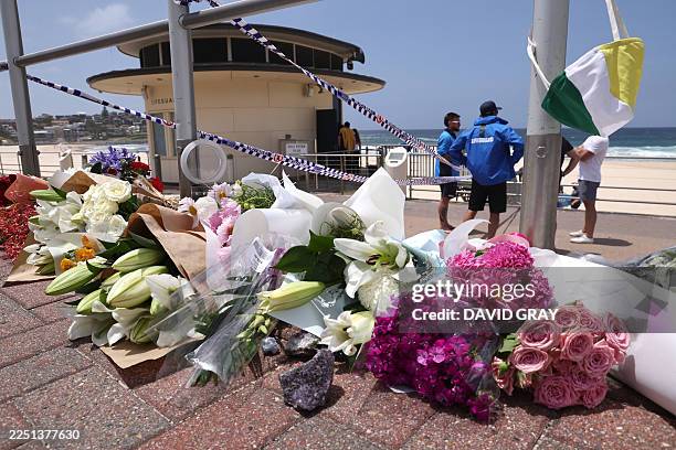 Flowers are placed outside the lifeguard tower at the Bondi Pavillion in memory of the victims of a shooting at Bondi Beach, in Sydney on December...