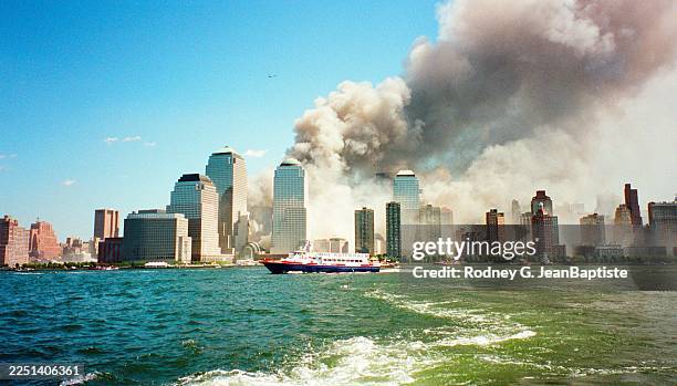 View, looking east across the Hudson River, of smoke rising from World Trade Center in the wake of the September 11 terrorist attacks, New York, New...