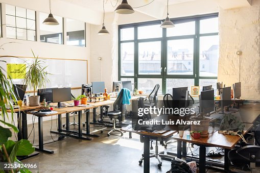 Empty startup office with multiple work stations Empty startup office with multiple work stations
