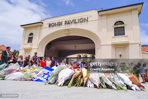 Growing display of flowers and tributes is seen at a memorial outside the Bondi Pavilion, honoring the victims of a mass shooting attack that killed...