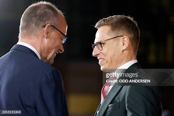 Finnish President Alexander Stubb is welcomed by German Chancellor Friedrich Merz at the Chancellery in Berlin on December 15, 2025 where European...