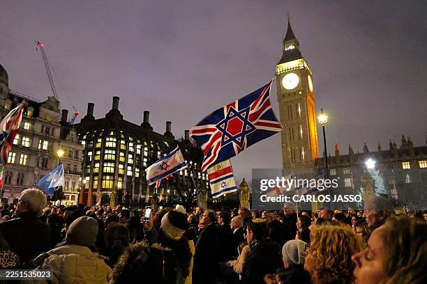 People take part in a Hanukkah candle-lighting organised by the Campaign Against Antisemitism and Jewish organisation Chabad Lubavitch in Parliament...