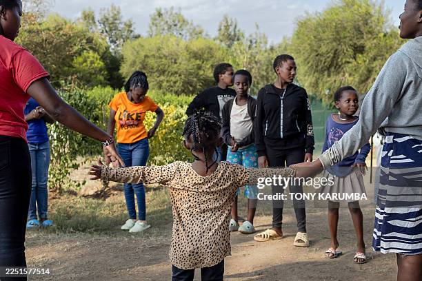 Juvenile girls, most from the Maasai community, play communal games during their free time at the House of Hope, a center that shelters and educates...