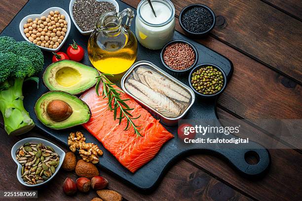 group of healthy ingredients high in unsaturated fatty acid and omega-3. food that improve cholesterol levels, lower blood pressure and reduce inflammation. olive oil, avocado, salmon, sardine, chia seed, nuts - ketogenic diet stock pictures, royalty-free photos & images