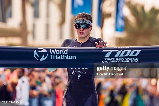 In this handout image provided by T100 Triathlon. Kate Waugh of Great Britain crosses the line to win the Qatar T100 Triathlon World Championship...