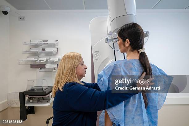 young woman undergoes mammogram - mammogram stock pictures, royalty-free photos & images