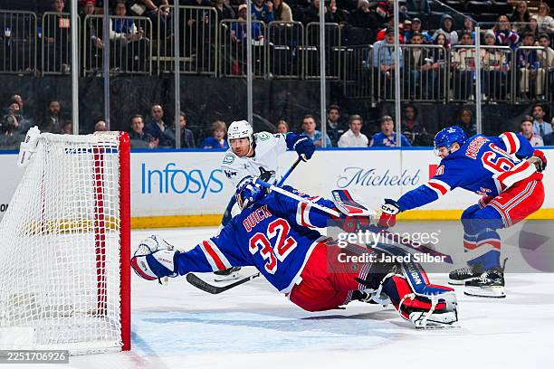 Jonathan Quick of the New York Rangers makes a save against Kiefer Sherwood of the Vancouver Canucks at Madison Square Garden on December 16, 2025 in...