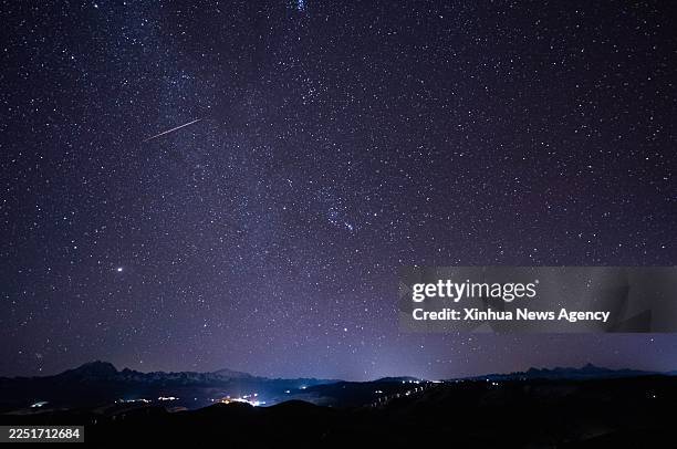 This photo taken on Dec. 15, 2025 shows the Geminid meteor shower in the sky over Balangshengdu Village, Kangding City of southwest China's Sichuan...
