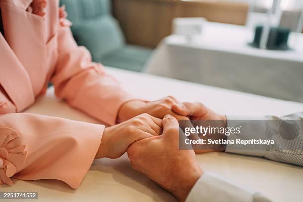 couple holding hands displaying love and connection on date - holding hands stock pictures, royalty-free photos & images