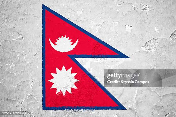 national flag of nepal painted on cracked concrete wall - nepal flag stock pictures, royalty-free photos & images