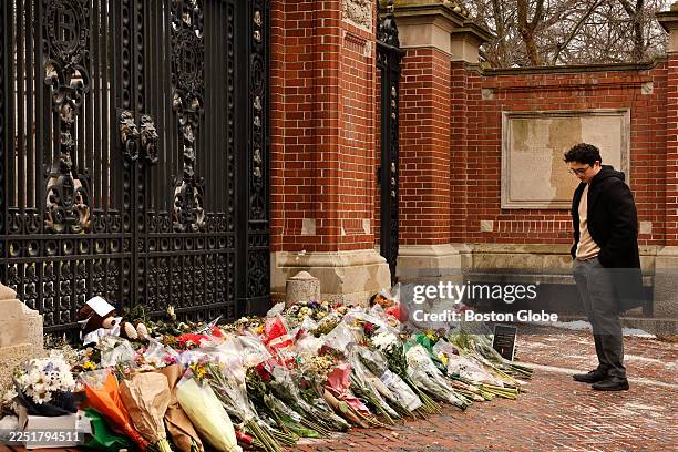 Providence, RI A student stands at the Van Wickle Gates of Brown University after laying down flowers on December 17, 2025.