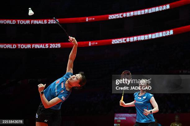 Japan's Yuki Fukushima and Mayu Matsumoto play a point during their women's doubles match against China's Jia Yifan and Zhang Shuxian at the BWF...
