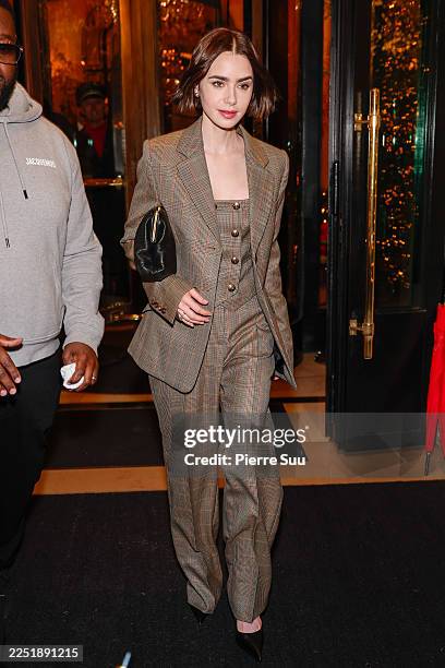 Lily Collins is seen leaving a hotel on December 14, 2025 in Paris, France.