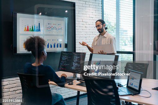 Software developers checking programming code on computer screen. Software developers checking programming code on computer screen.