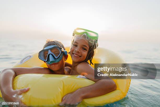 kids having fun on summer vacation - inflatable stock pictures, royalty-free photos & images