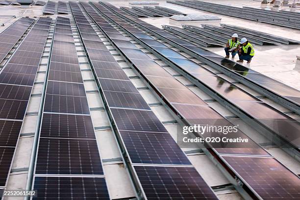 technicians inspecting a solar panel installtion - sun safety stock pictures, royalty-free photos & images