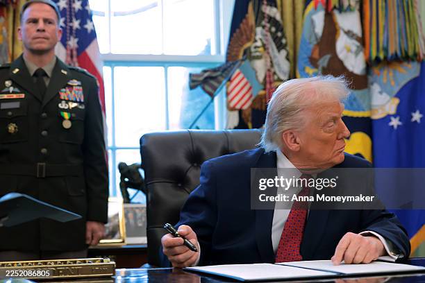 President Donald Trump signs an executive order classifying fentanyl as a "weapon of mass destruction," during a ceremony for the presentation of the...