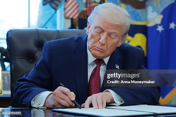 President Donald Trump signs an executive order classifying fentanyl as a "weapon of mass destruction," during a ceremony for the presentation of the...