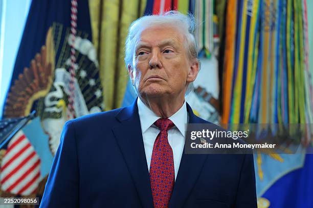 President Donald Trump listens during a ceremony for the presentation of the Mexican Border Defense Medal in the Oval Office of the White House on...