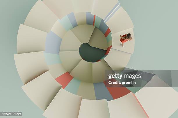 woman walking on stairs posing as graph - spiral staircase stock pictures, royalty-free photos & images
