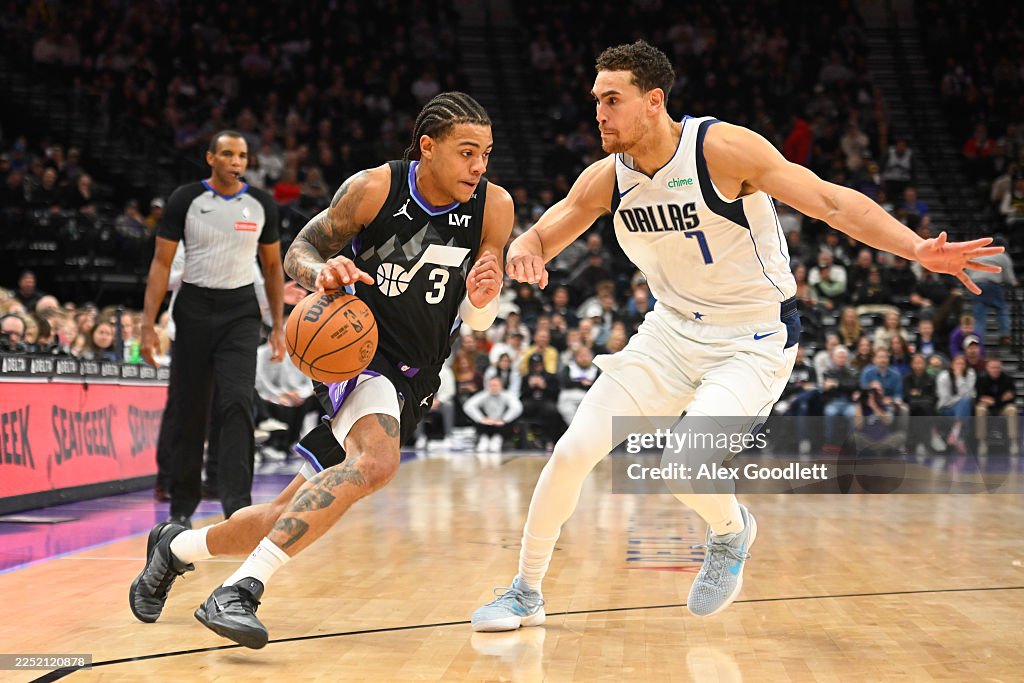 Keyonte Powell Keyonte George of the Utah Jazz drives into Dwight Powell of the ...