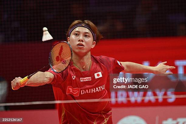 Japan's Kodai Naraoka hits a return to France's Christo Popov during their men's singles semifinal match at the BWF Badminton World Tour Finals at...