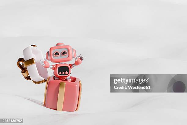 3d robot emerging from a gift box in a festive christmas setting - engineering machinery stock illustrations