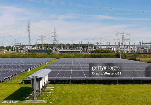 solar farm with power lines and transformer station in the netherlands - elnät bildbanksfoton och bilder