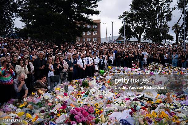 People participate in a candlelight vigil at Bondi Pavilion at Bondi Beach on December 16, 2025 in Sydney, Australia. Police say at least 16 people,...