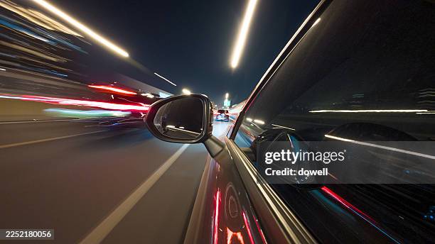 speeding car in illuminated tunnel at night - speed stock pictures, royalty-free photos & images