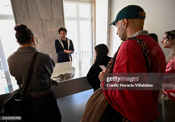 Exhibition curator Pedro Ferreira briefs visitors during the press visit to “Alexandre Farto Aka Vhils. Selected Editions. 2008-2024”, an exhibition...