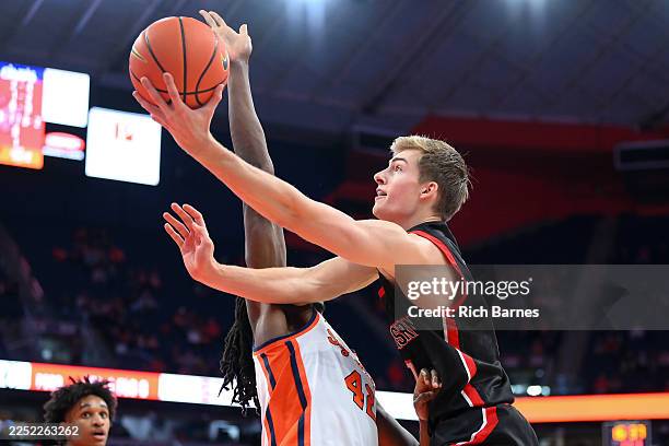 Youri Fritz of the Northeastern Huskies shoots against William Kyle III of the Syracuse Orange during the first half at the JMA Wireless Dome on...