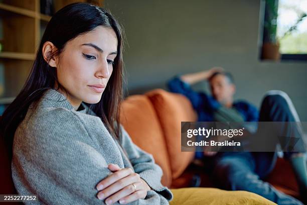 woman feeling sad after argument with partner at home - infidelity stock pictures, royalty-free photos & images