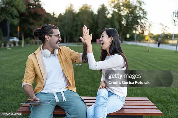 diverse friends giving high five for success - boa notícia imagens e fotografias de stock