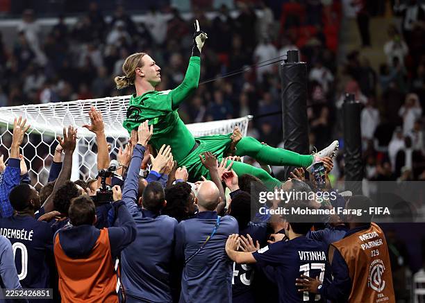 Matvey Safonov of Paris Saint-Germain is thrown into the air by his teammates after they win the penalty shoot out during the FIFA Intercontinental...