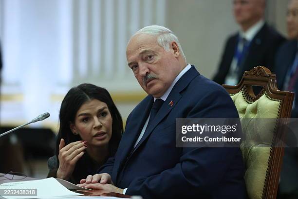 Belarusian President Alexander Lukashenko listens to his press secretary Natalya Eismont during the Eurasian Economic Union Summit, on December 21,...