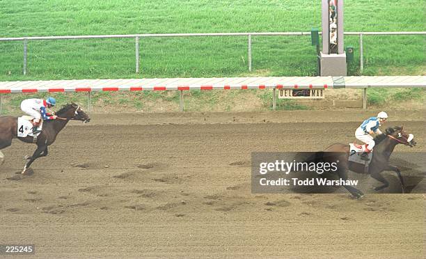 Jockey Alex Solis crosses the finish line aboard Dare And Go ahead of second place Cigar, ridden by Jerry Bailey, in the Pacific Classic at Del Mar...