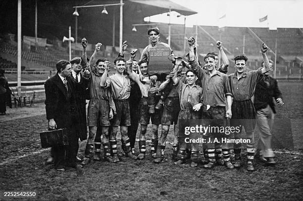 The Richmond Social team carrying their captain with the Shield after winning the final in the London Occupational Football Shield Competition,...