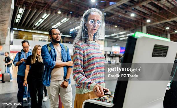 passenger passing on biometric facial recognition at airport - biometrics stock pictures, royalty-free photos & images