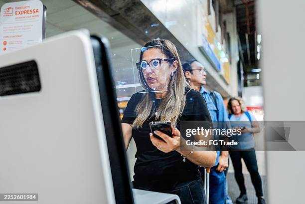 passenger passing on biometric facial recognition at airport - biometrics stock pictures, royalty-free photos & images