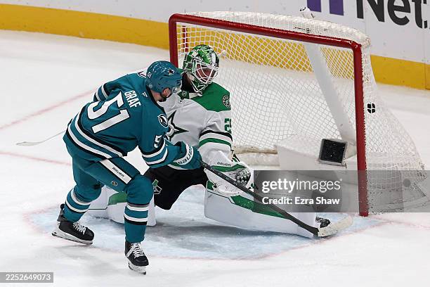 Collin Graf of the San Jose Sharks scores on Jake Oettinger of the Dallas Stars during the second period at SAP Center on December 18, 2025 in San...