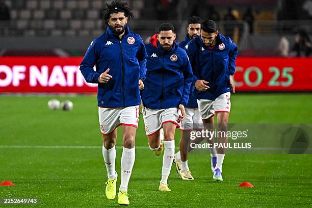 Tunisia's midfielder Ferjani Sassi, Tunisia's defender Dylan Bronn, Tunisia's forward Elias Saad and Tunisia's forward Hazem Mastouri warm up during...