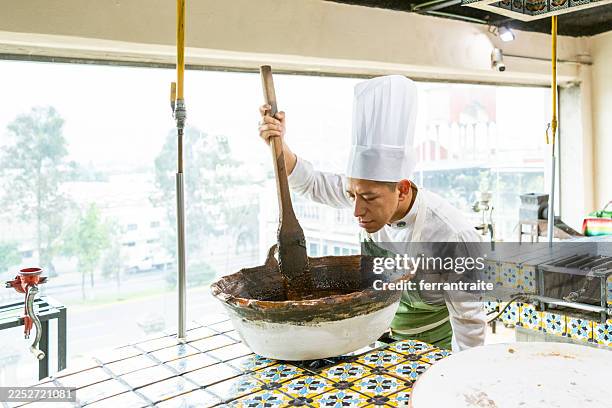 chef cooking mole - chef stirring stock pictures, royalty-free photos & images