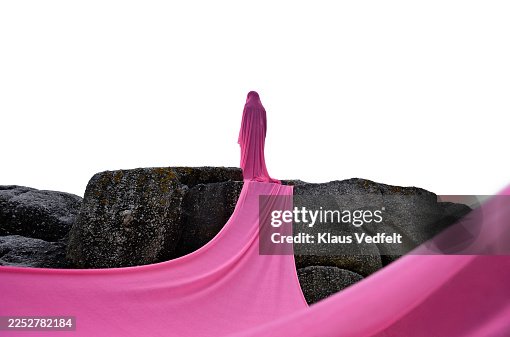 Young non-binary individual wrapped in pink cloth Young non-binary individual wrapped in pink cloth