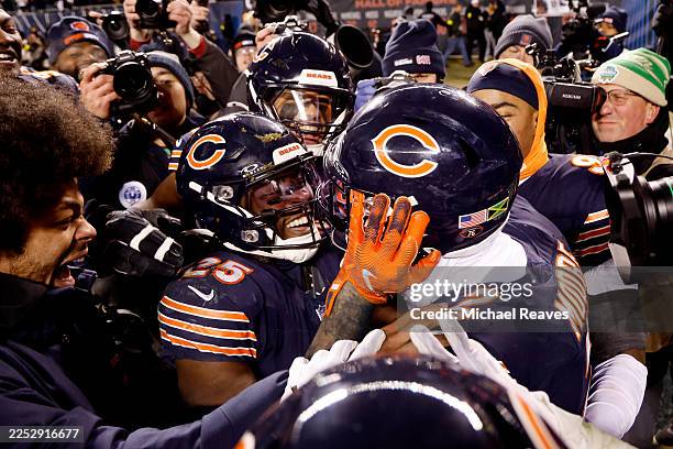 Moore of the Chicago Bears celebrates with Kyle Monangai and teammates after catching a touchdown pass against the Green Bay Packers in overtime at...