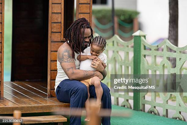 afro father and son playing in the playground - ethnicity stock pictures, royalty-free photos & images
