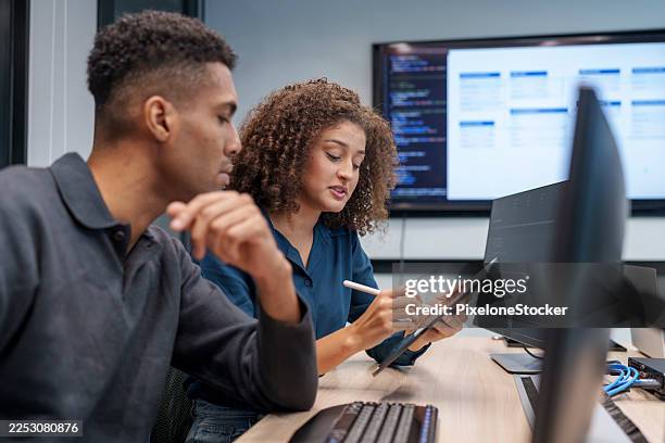 two computer programmers working together on a computer code at office. - cloud computing security stock pictures, royalty-free photos & images