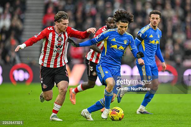 Dennis Cirkin of Sunderland FC attempts to stop Ao Tanaka of Leeds United during the Premier League match between Sunderland and Leeds United at the...